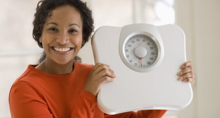 Weight loss - Woman with weighing scale