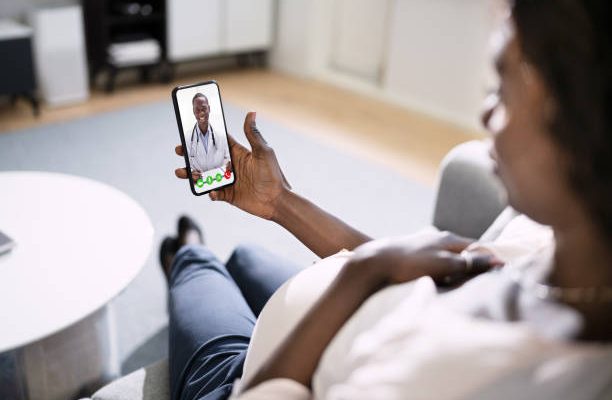 Pregnant African Women Doctor Video Call On Laptop At Home